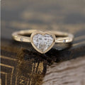 1.5 Carat Heart Shaped Moissanite Solitaire Ring with Floating Rounds Tapered Band Symbolic Bezel Set Gemstone Rings