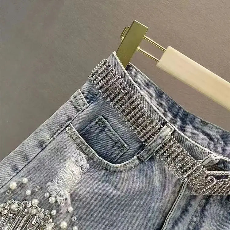 Women High-Waisted Rhinestone Pearl Fringe Denim Shorts Light Wash Distressed Design with Sparkly Belt Tassel Trim Shorts