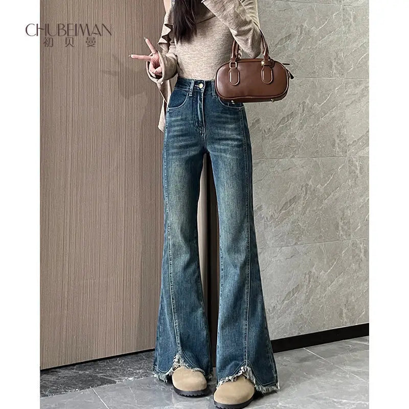 Women's stylish denim jeans, stretchy blue-gray with frayed edges, slit, high-waisted, leg-lengthening, flared