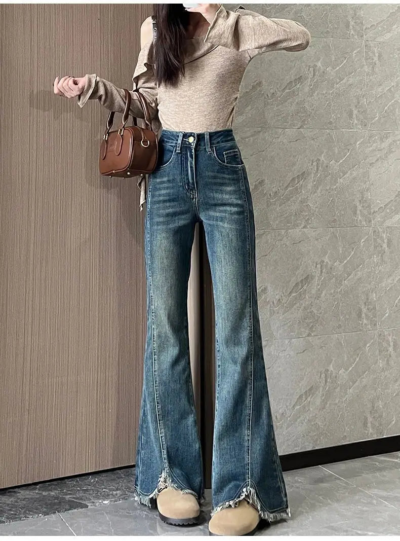 Women's stylish denim jeans, stretchy blue-gray with frayed edges, slit, high-waisted, leg-lengthening, flared