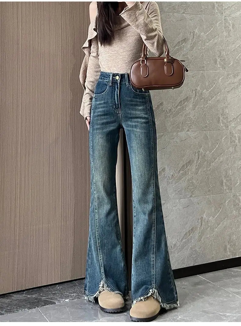 Women's stylish denim jeans, stretchy blue-gray with frayed edges, slit, high-waisted, leg-lengthening, flared