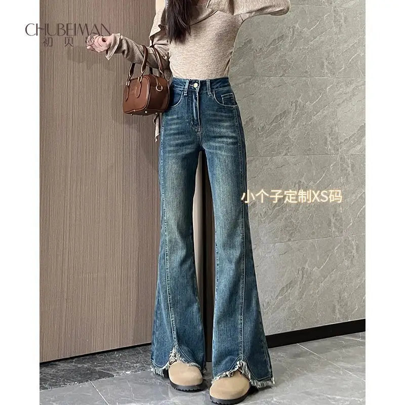 Women's stylish denim jeans, stretchy blue-gray with frayed edges, slit, high-waisted, leg-lengthening, flared