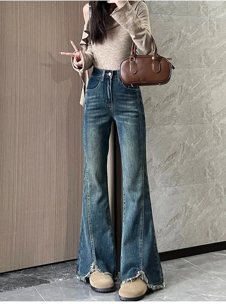 Women's stylish denim jeans, stretchy blue-gray with frayed edges, slit, high-waisted, leg-lengthening, flared