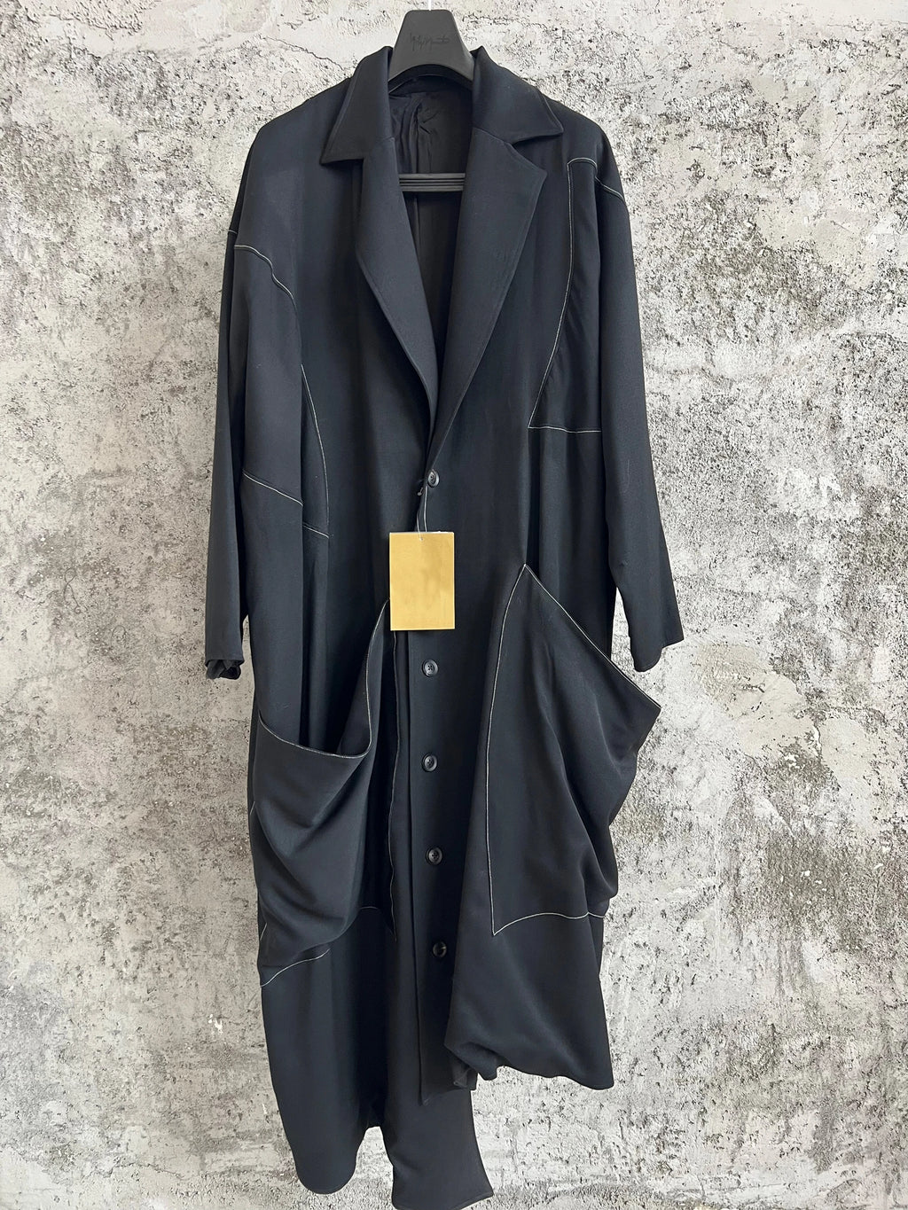 TOP-YAMAMOTO, a niche designer of mid-length trench coats made of pure wool with fringed edges
