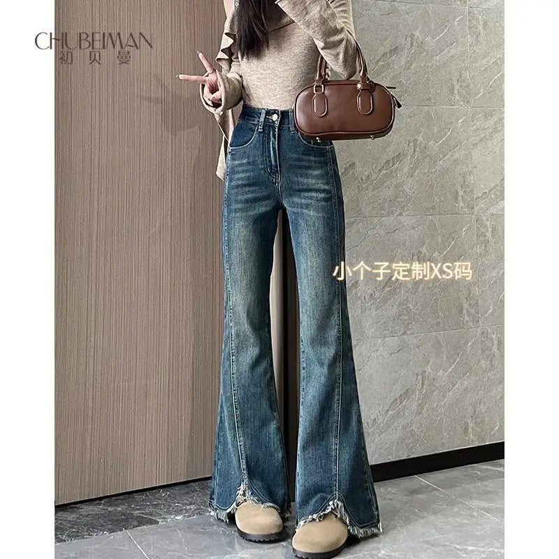 Women's stylish denim jeans, stretchy blue-gray with frayed edges, slit, high-waisted, leg-lengthening, flared