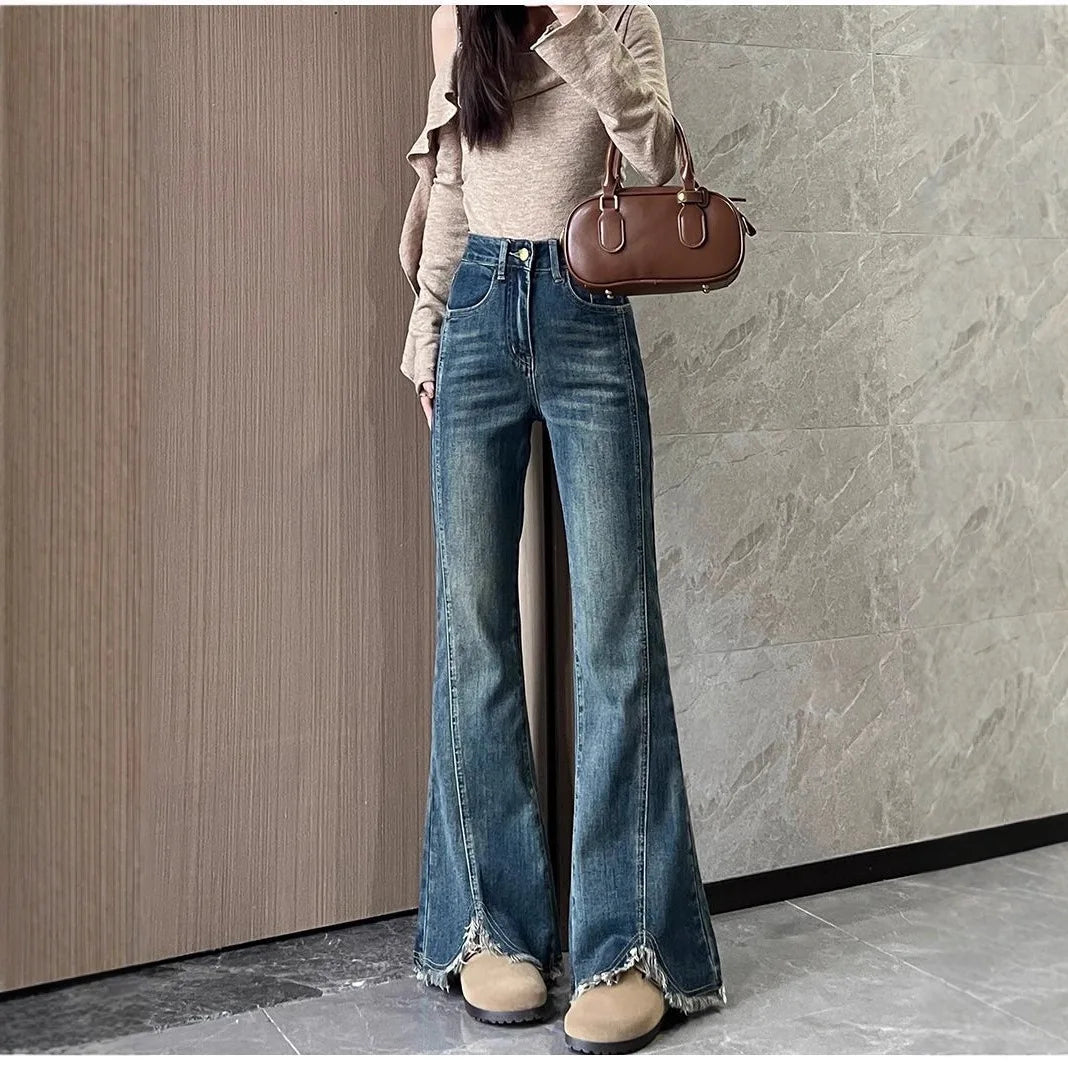 Women's stylish denim jeans, stretchy blue-gray with frayed edges, slit, high-waisted, leg-lengthening, flared