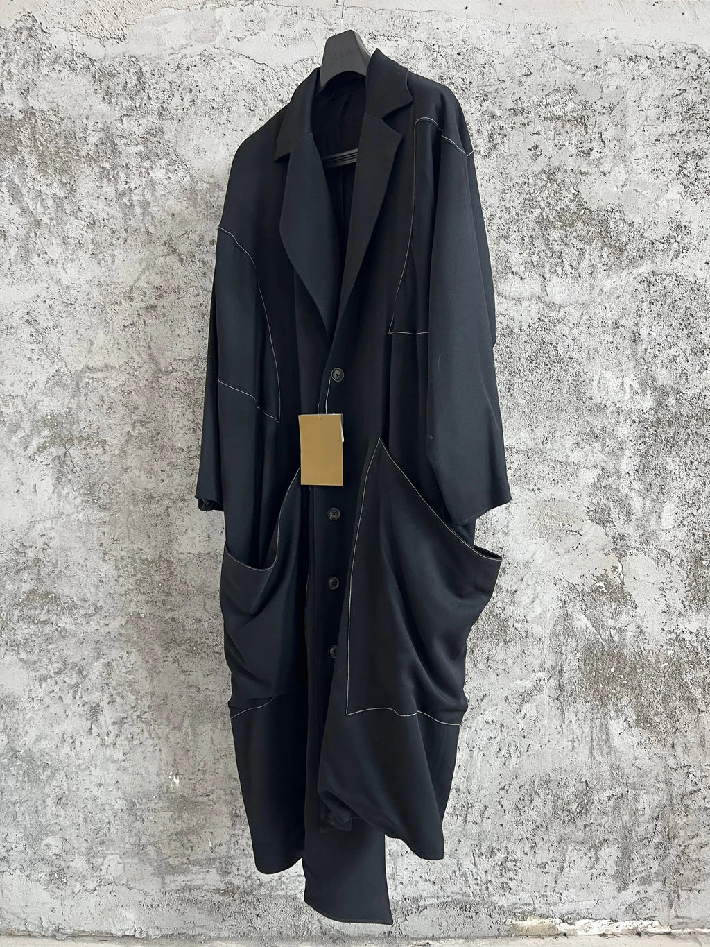 TOP-YAMAMOTO, a niche designer of mid-length trench coats made of pure wool with fringed edges