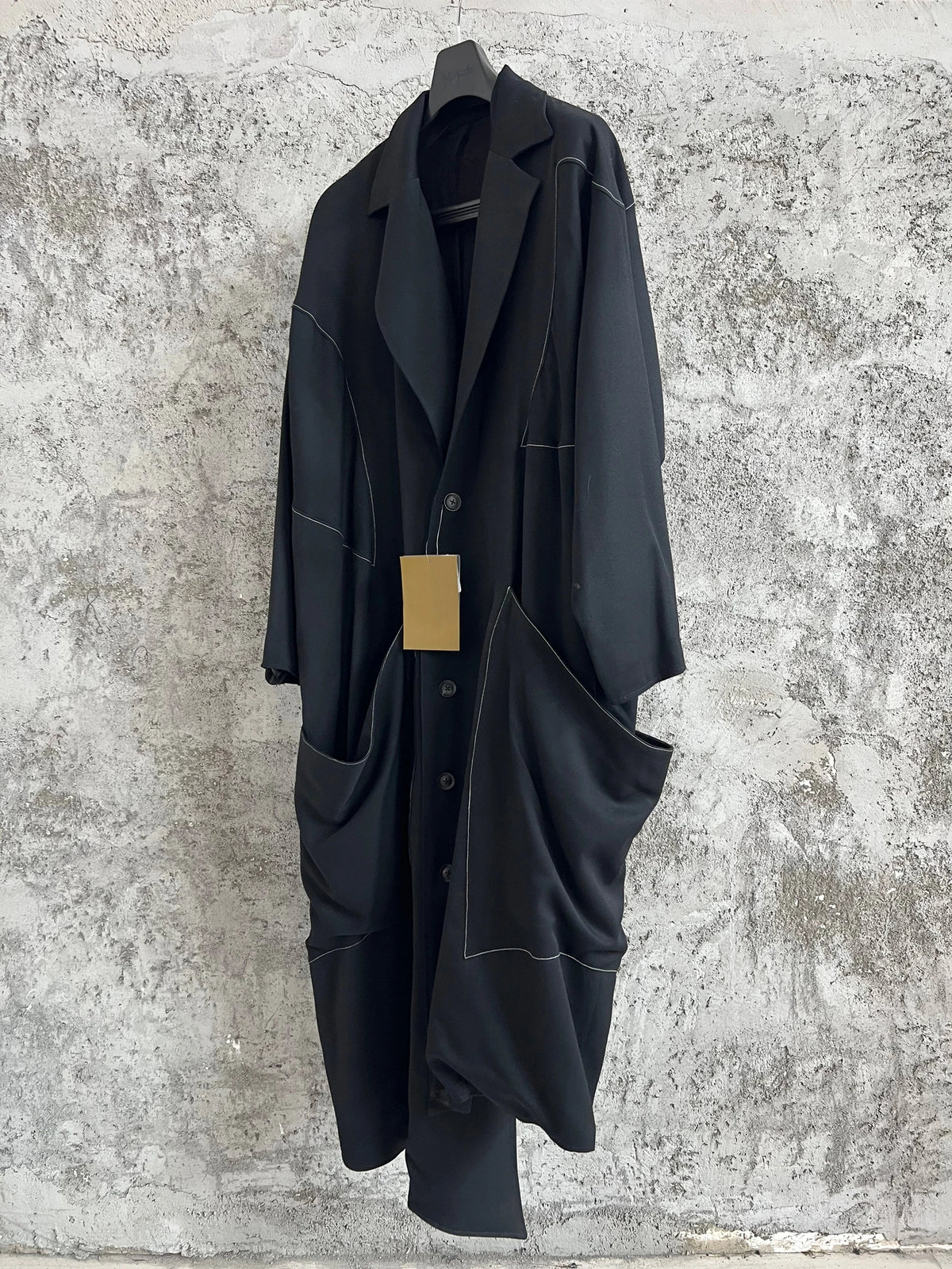 TOP-YAMAMOTO, a niche designer of mid-length trench coats made of pure wool with fringed edges